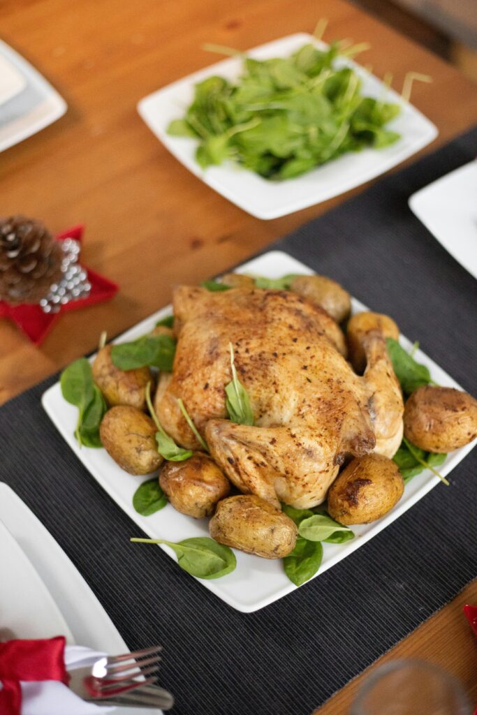 Roasted chicken served with potatoes and leafy greens, perfect for home dining.